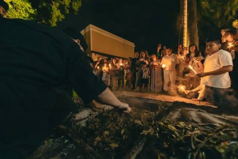 Chef preparing mucbipollo, a traditional Yucatan delicacy, using an underground oven, an ancient cooking method that imbues the dish with smoky, rich flavours