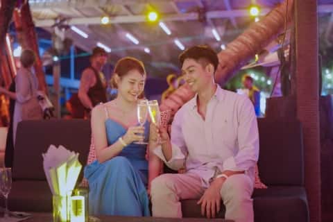 Couple enjoying drinks at a night market in Thailand
