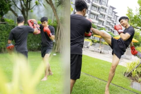 Man practicing Muay Thai with a trainer