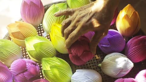 Traditional craft session creating paper lotus flowers at Angsana Lang Co