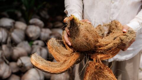 A coconut husk that is used to be woven into ropes and mats 