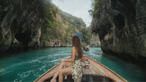 A woman enjoying the views while on a Traditional Longtail Boat
